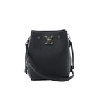 Louis Vuitton LockMe black grained leather bucket bag with silver-tone LV lock, drawstring side ties, slim crossbody strap and open top on white background.