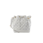 White Louis Vuitton Petit Noé NM bucket bag with Monogram cutout pattern, drawstring closure, gold-tone grommets, and adjustable shoulder strap.