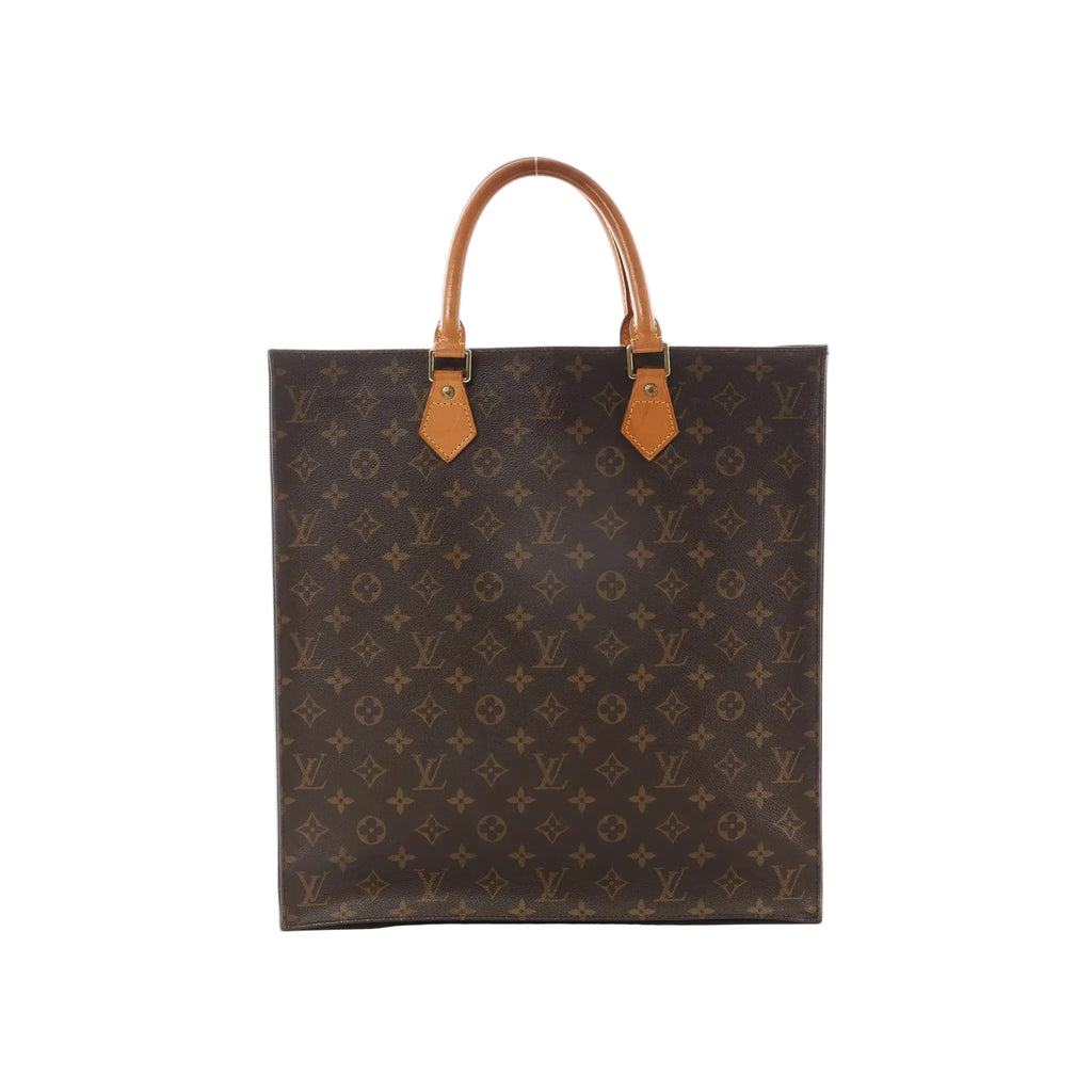 Louis Vuitton Sac Plat brown Monogram canvas tote bag with vachetta leather top handles and gold-tone hardware on white background.