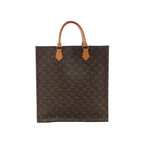Louis Vuitton Sac Plat brown Monogram canvas tote bag with vachetta leather top handles and gold-tone hardware on white background.