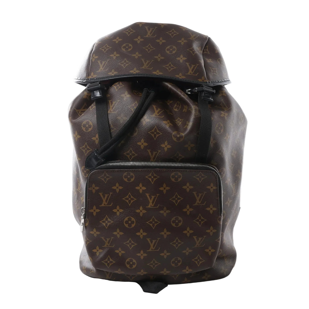 Louis Vuitton Zack Macassar backpack in brown Monogram canvas with black trim, front zip pocket, flap top closure and drawstring opening.
