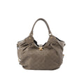 Front view of Louis Vuitton Mahina L shoulder bag in taupe-brown perforated Monogram leather with gold-tone clasp, studded leather handle attachments, and soft slouchy shape.