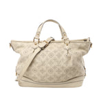 Front view of Louis Vuitton Monogram Mahina Stella PM Leather Handbag M93067 in beige perforated leather with signature LV monogram pattern, gold-tone hardware, double top handles, and adjustable shoulder strap, displayed against a white background.