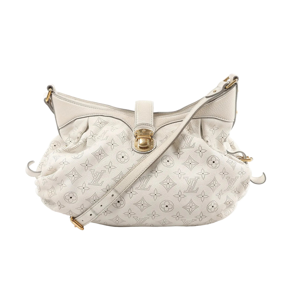 White Louis Vuitton Mahina XS bag in perforated Monogram leather with gathered silhouette, gold-tone front clasp, and adjustable shoulder strap.
