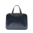 Front view of a navy blue Louis Vuitton Malden handbag in embossed Monogram Mat leather with dual handles, silver-tone hardware and a front pocket.
