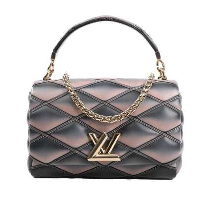 Front view of the Louis Vuitton GO-14 MM Malletage crossbody bag M23569, featuring quilted black and pink lambskin leather, gold-tone chain strap, and signature gold LV twist-lock closure.
