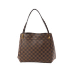 Louis Vuitton Damier Ebene checkered canvas shoulder bag with dark brown leather straps and gold-tone strap attachments