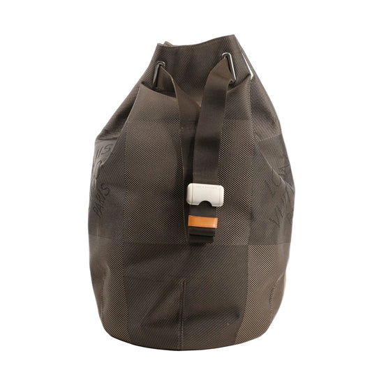 Louis Vuitton Matero PM shoulder bag in gray Damier Geant canvas with oversized check pattern, top drawstring closure, and adjustable web strap with silver-tone buckle.