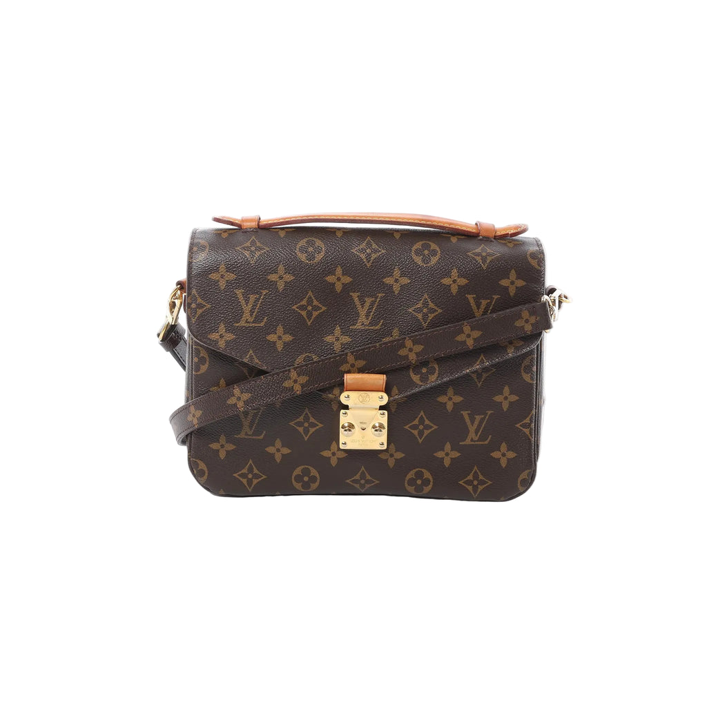 Front view of Louis Vuitton Monogram canvas Pochette Métis MM with tan leather top handle, gold-tone S-lock clasp, and crossbody strap on white background.