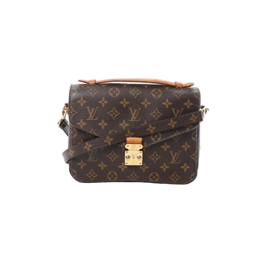 Front view of Louis Vuitton Monogram canvas Pochette Métis MM with tan leather top handle, gold-tone S-lock clasp, and crossbody strap on white background.