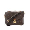 Louis Vuitton Monogram canvas Pochette Métis crossbody bag with top handle, adjustable strap with gold eyelets, and gold-tone S-lock front closure