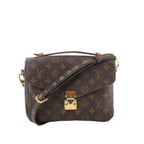 Louis Vuitton Monogram canvas Pochette Métis crossbody bag with top handle, adjustable strap with gold eyelets, and gold-tone S-lock front closure