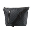 Louis Vuitton Mick PM bag in black and grey Damier Graphite canvas with a vertical front zip pocket and adjustable black strap draped across the front.