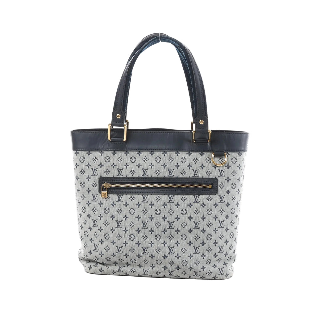 Louis Vuitton Mini Lucille GM tote in grey Monogram linen with navy leather trim, gold-tone hardware, and front zip pocket on white background.