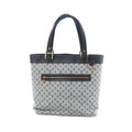 Louis Vuitton Mini Lucille GM tote in grey Monogram linen with navy leather trim, gold-tone hardware, and front zip pocket on white background.