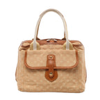 Beige Louis Vuitton Mini Monogram handbag with brown leather trim, striped top handles, front flap pocket and silver-tone zip hardware.