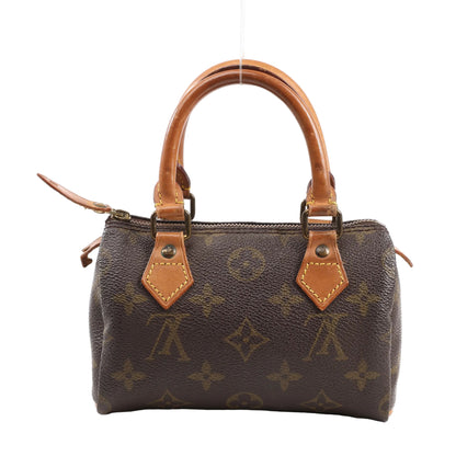 Louis Vuitton Nano Speedy Handbag M41534 in brown Monogram canvas with natural leather top handles, gold-tone zipper, and contrast yellow stitching, displayed upright on a white background.