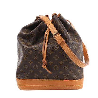 Louis Vuitton Monogram Noé Shoulder Bag M42224 in brown coated canvas with all-over LV monogram, natural leather base and trim, adjustable shoulder strap, and leather drawstring closure, shown standing upright on a white background.