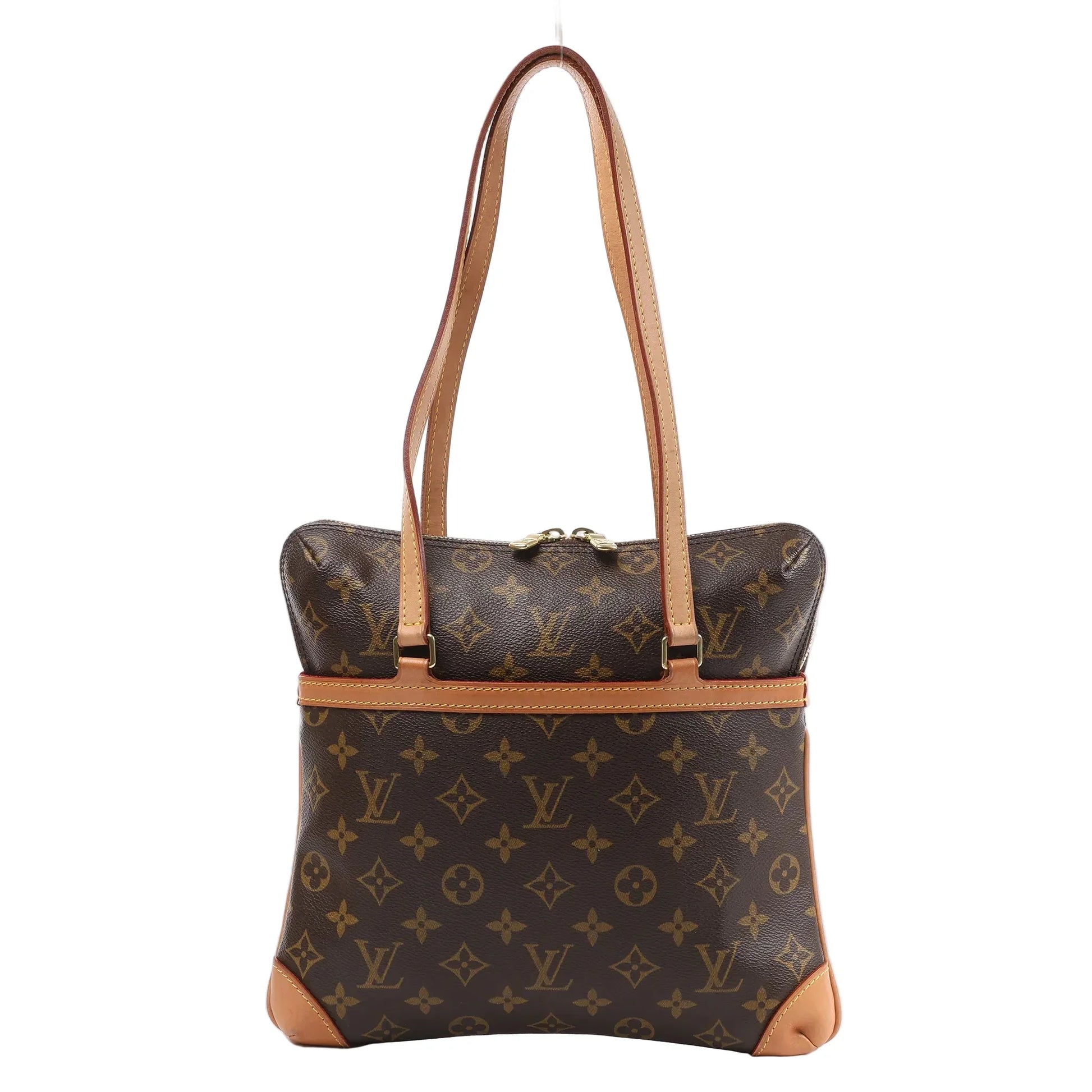 Louis Vuitton Monogram Coussin GM Shoulder Bag in brown coated canvas with natural leather trim, dual flat shoulder straps, and gold-tone zipper, displayed on a white background.