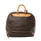 Front view of Louis Vuitton Monogram Canvas Evasion Weekend Handbag M41443 in brown monogram coated canvas, featuring natural leather top handles, gold-tone hardware, and front zip pocket against a white background.