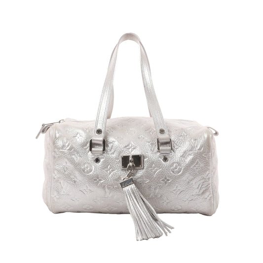 Louis Vuitton Comète Limited Edition shoulder bag in shimmer silver Monogram-embossed leather, featuring dual handles, front tassel accent, and metallic finish.