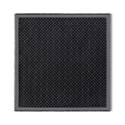 Black patterned fabric square on a white background