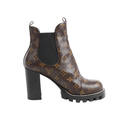 Louis Vuitton Monogram Star Trail Chelsea Ankle Boots in brown Monogram canvas, size 40 EU, with black elastic side panels, pull tabs, block heels, and lug soles, displayed in profile against a white background.