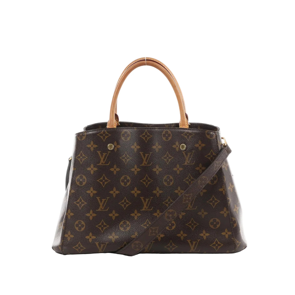 Louis Vuitton Montaigne MM brown Monogram canvas handbag with vachetta top handles and detachable shoulder strap on white background.