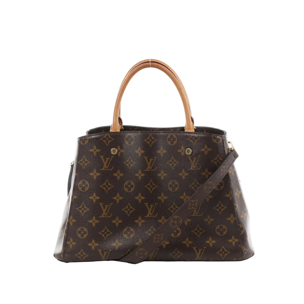 Louis Vuitton Montaigne MM brown Monogram canvas handbag with vachetta top handles and detachable shoulder strap on white background.