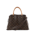 Louis Vuitton Montaigne MM brown Monogram canvas handbag with vachetta top handles and detachable shoulder strap on white background.