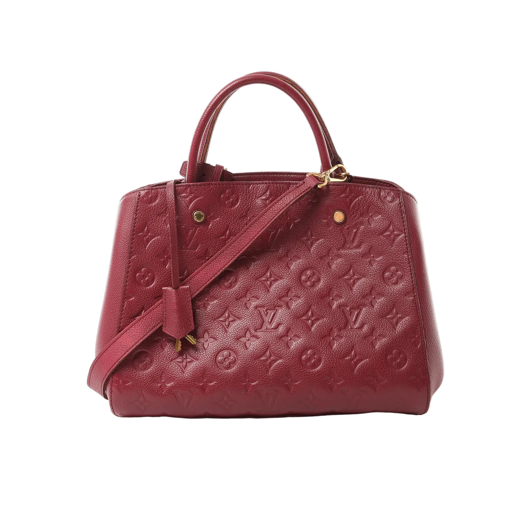 Burgundy Louis Vuitton Montaigne MM Monogram Empreinte leather handbag with top handles, detachable shoulder strap, and gold-tone hardware on a white background.