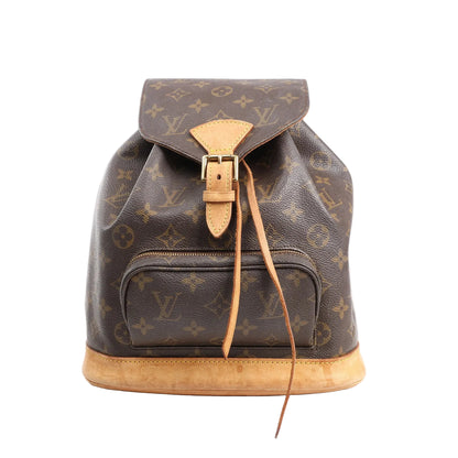 Louis Vuitton Montsouris MM vintage backpack in brown Monogram canvas with natural cowhide leather trim, front zip pocket, buckle flap closure, and drawstring, shown on a white background.