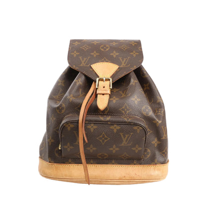 Louis Vuitton Montsouris MM vintage backpack in brown Monogram canvas with natural leather trim, buckle flap closure, drawstring, and front zip pocket, displayed on a white background.