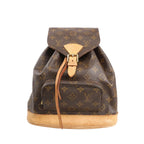 Louis Vuitton Montsouris MM vintage backpack in brown Monogram canvas with natural leather trim, buckle flap closure, drawstring, and front zip pocket, displayed on a white background.