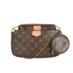 Louis Vuitton Multi Pochette Accessoires in brown Monogram canvas with two zip pouches, gold chain strap, and round coin purse charm on white background