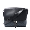 Louis Vuitton Newport PM messenger bag in navy Damier Cobalt canvas with black leather flap, silver-tone buckle and adjustable shoulder strap.