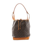Louis Vuitton Noé brown Monogram canvas bucket shoulder bag with vachetta leather base and trim, drawstring closure with leather ties, and an adjustable vachetta shoulder strap, shown on a white background.