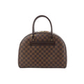 Louis Vuitton Nolita handbag in brown Damier Ebene check canvas with dark leather top handles, zip-top closure, and a front leather nameplate on a white background.
