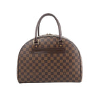Louis Vuitton Nolita handbag in brown Damier Ebene check canvas with dark leather top handles and zip-top closure on white background