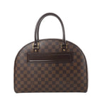 Front view of Louis Vuitton Nolita handbag in brown Damier Ebene canvas with dark leather top handles, gold-tone hardware, and front leather logo patch.