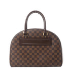 Louis Vuitton Nolita Damier Ebene brown checkered handbag with dark brown leather top handles, leather front nameplate, and gold-tone hardware on white background