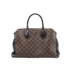 Louis Vuitton Normandy handbag in brown Damier Ebene canvas with black leather side panels, dark leather top handles, and gold-tone hardware on a light gray background.