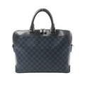 Louis Vuitton Oliver handbag in navy Damier Cobalt checker canvas with black leather top panel and handles, silver-tone double zipper, and structured shape.