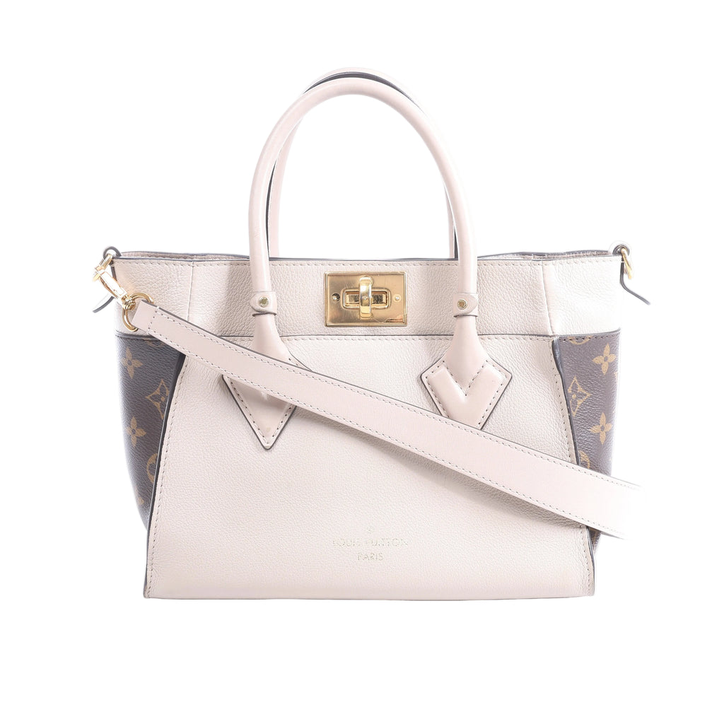 Beige Louis Vuitton On My Side PM leather handbag with brown Monogram canvas side panels, top handles, shoulder strap and gold-tone turn-lock.