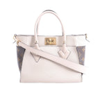 Beige Louis Vuitton On My Side PM leather handbag with brown Monogram canvas side panels, top handles, shoulder strap and gold-tone turn-lock.