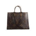 Front view of Louis Vuitton OntheGo GM brown Giant Monogram tote with contrasting Monogram Reverse top handles and long black shoulder straps.