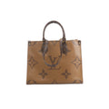 Front view of Louis Vuitton OntheGo MM in brown Giant Monogram Reverse with dark Monogram top handles, long shoulder straps and gold-tone hardware.