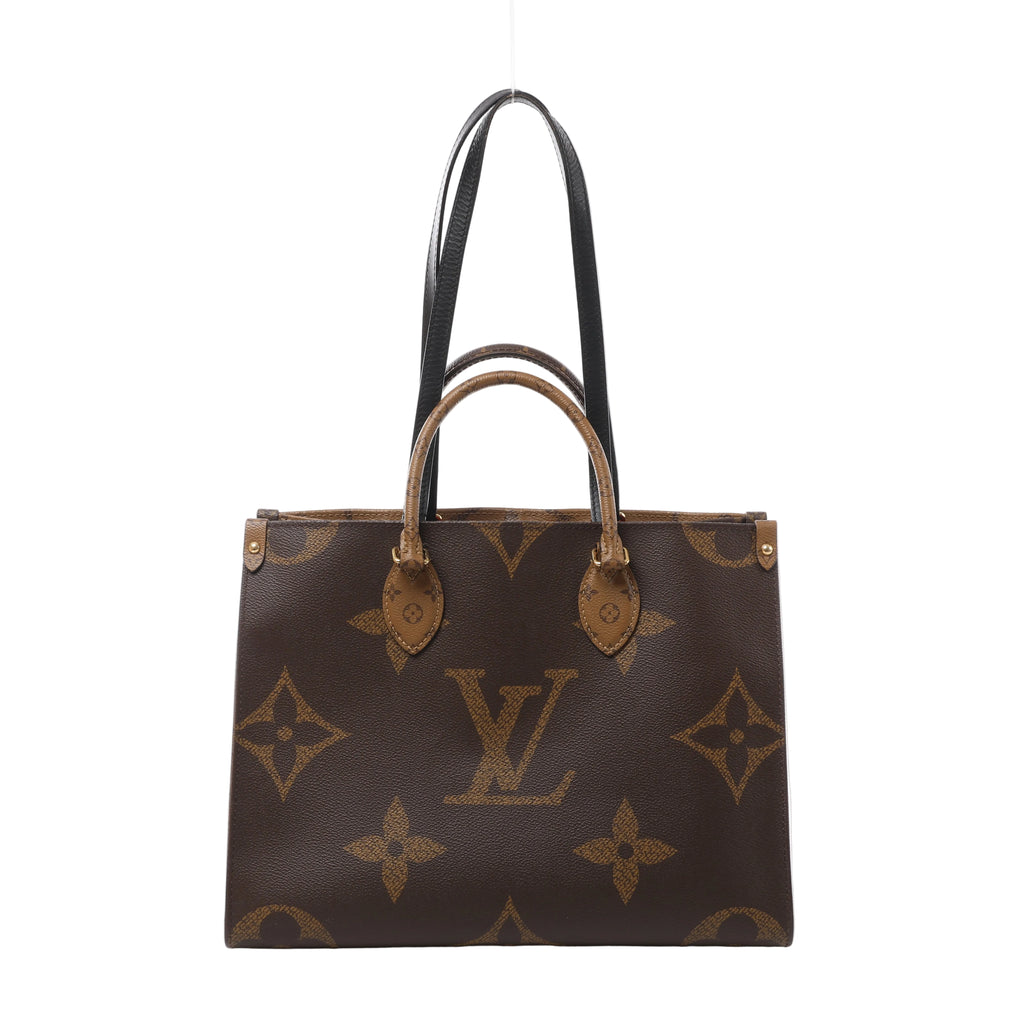 Front view of a brown Louis Vuitton OnTheGo tote with oversized Monogram motifs, rolled top handles, long black shoulder straps and gold-tone fittings.