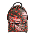 Louis Vuitton Palm Springs PM backpack in brown Monogram canvas with pink palm leaf and red dot Jungle Dots print, gold-tone zippers, and top handle design.