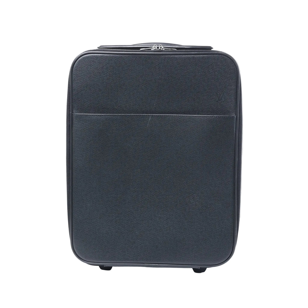 Front view of a black Louis Vuitton Pegase 45 Taiga leather rolling travel bag with zip closure, front pocket and visible wheels on a white background.